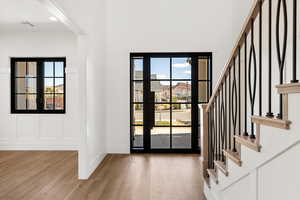 Foyer with stairway and light wood finished floors