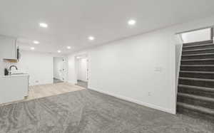 living room featuring recessed lighting and light carpet