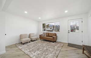 Living room featuring light wood-style floors and recessed lighting