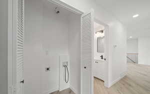 Laundry area featuring light wood-type flooring, washer hookup, recessed lighting, and hookup for an electric dryer