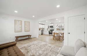 Living room featuring light wood-style flooring and recessed lighting
