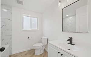 Full bath with vanity, light wood-type flooring, and washtub / shower combination