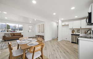 Dining space with light wood-style floors and recessed lighting