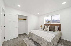 Master bedroom with carpet flooring, a closet, and recessed lighting