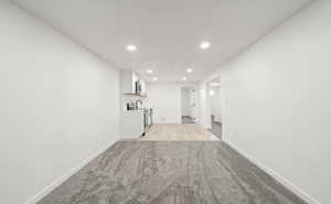 iving room with recessed lighting and light carpet