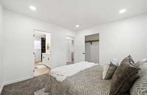 Master bedroom with a closet, ensuite bathroom, and recessed lighting
