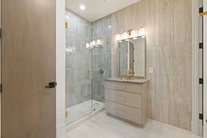 Bathroom featuring vanity, a stall shower, and recessed lighting