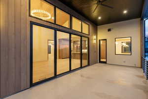 Property entrance with a ceiling fan and a patio