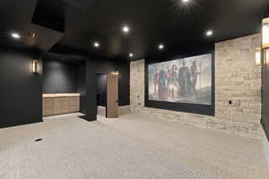 Home theater with light carpet and recessed lighting