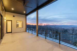 Patio terrace at dusk featuring a patio and a ceiling fan