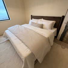 Bedroom featuring carpet and baseboards