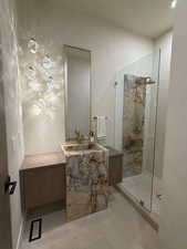 Full bath featuring vanity and a tile shower