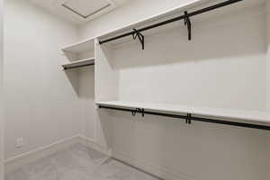 Walk in closet featuring attic access