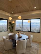 Dining space with wood finished floors, wooden ceiling, and recessed lighting