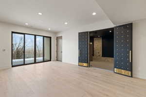 Spare room featuring light wood-type flooring and recessed lighting