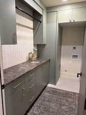 Kitchen with gray cabinetry and dark stone counters
