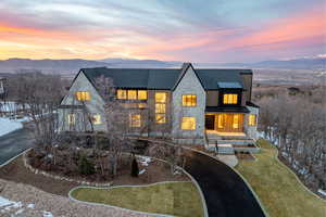 View of front facade with a standing seam roof, stone siding, and a mountain view