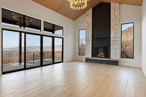 22' vaulted ceilings with stone/plaster fireplace grand chandelier, European white oak flooring and trim in entryways and window sills. With large sliding glass doors onto the covered patio with the grand view.