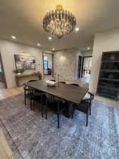 Dining area featuring light wood-type flooring and hanging lights