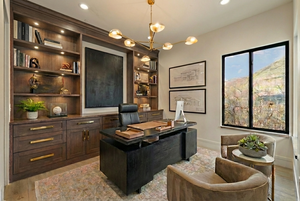 Office area featuring light wood-style floors, suspended lighting, and built in shelves