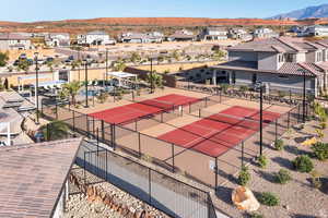 View of tennis court featuring a residential view, a mountain view, and a patio