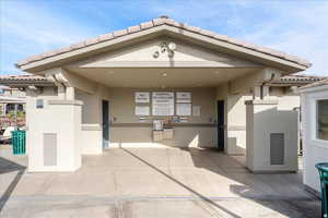 Doorway to property featuring a tiled roof and stucco siding
