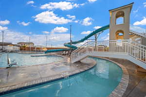 Community pool featuring a patio area and a water slide