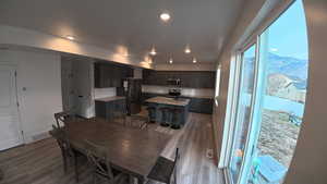 Dining room with light wood finished floors, recessed lighting, and a mountain view
