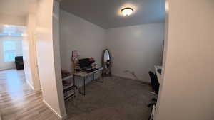 Home office featuring baseboards and light carpet
