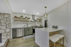 Kitchen with a kitchen breakfast bar, open shelves, backsplash, light stone countertops, and light wood-type flooring