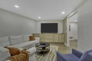 Living room with recessed lighting and light wood-style floors
