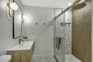 Bathroom with a stall shower and vanity
