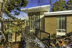 View of exterior entry featuring brick siding