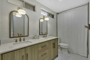 Bathroom with double vanity and toilet