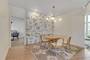 Dining room featuring light wood finished floors, a chandelier, and recessed lighting