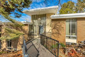 Entrance to property featuring brick siding