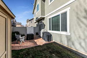 Fenced backyard with a gate and a patio area