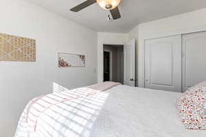 Bedroom with ceiling fan and a closet