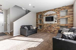 Tiled living room with carpet and built in shelves