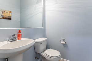 Half bathroom with toilet and a sink