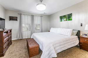 Carpeted bedroom featuring baseboards