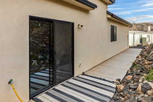 Property entrance with stucco siding and a mountain view