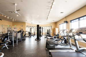 Gym with track lighting and ceiling fan