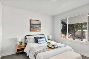 Bedroom featuring carpet and a textured wall