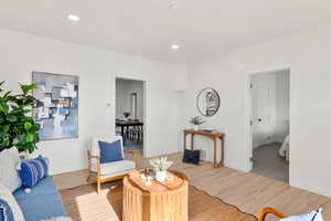 Living area with wood finished floors and baseboards