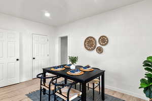 Dining room featuring baseboards and light wood-style flooring