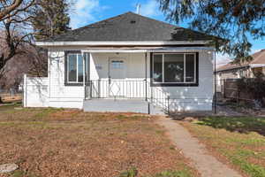 View of front of home with a porch and a shingled roof