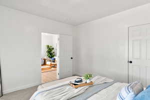 Bedroom with carpet flooring and a textured wall