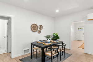 Dining area featuring light wood-style flooring and recessed lighting
