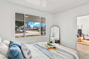 Bedroom with wood finished floors and baseboards